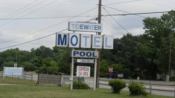 A motel sign with 'Tidewater Motel' and 'Pool' indicating amenities.