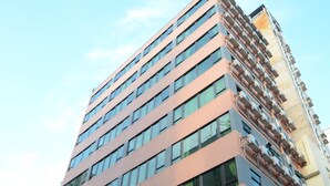 Un immeuble de grande hauteur, doté de nombreux étages, de grandes fenêtres et d’une architecture moderne.