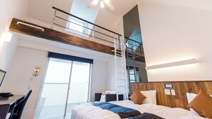 A modern hotel room with a lofted sleeping area, a desk, and a large window. - LiVEMAX RESORT Izu Shimoda (Shimoda)