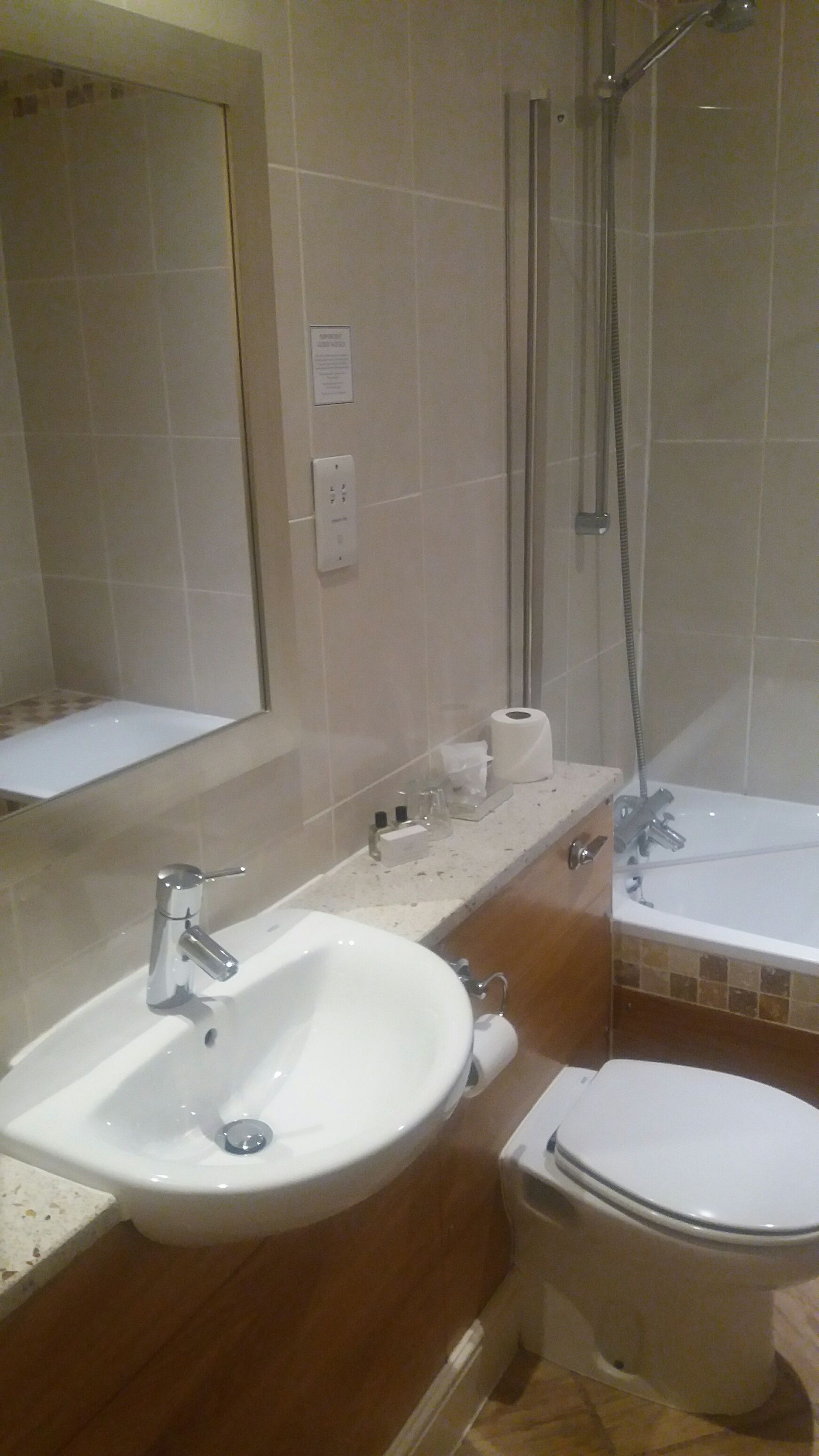 A bathroom with a sink, toilet, and shower.
