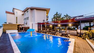 Seasonal outdoor pool, open 9:00 AM to 7:00 PM, pool umbrellas