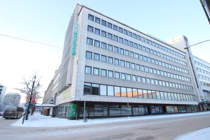 Un hotel de varios pisos con una fachada moderna, ventanas amplias y techo plano.