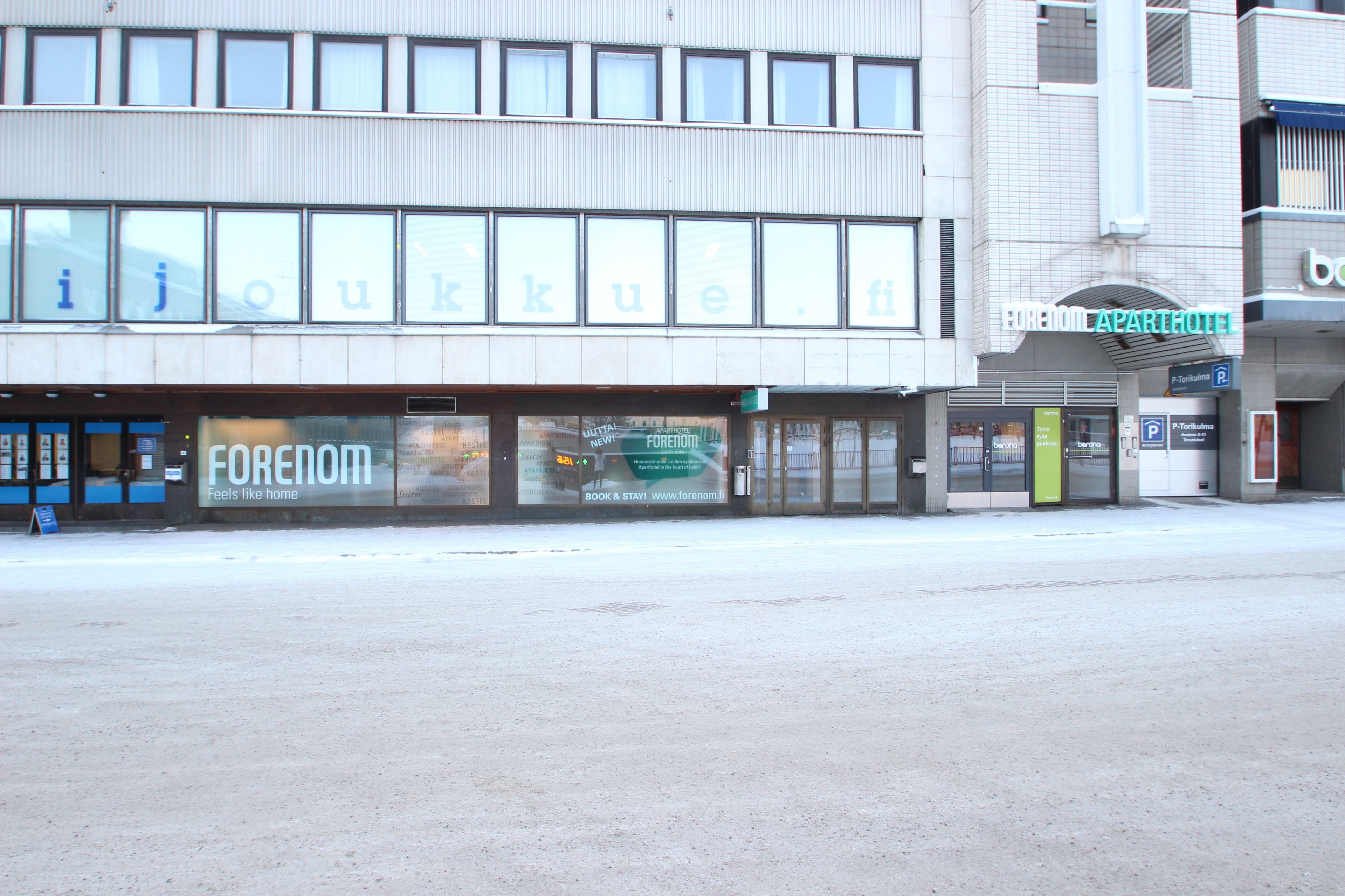 A building with a storefront labeled "FORENOM" and a sign for "FORENOM APARTHOTEL" above the entrance.