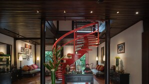 A modern interior with a spiral staircase, a coffee table, and a sofa.