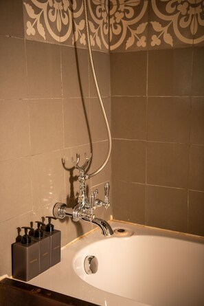 Deluxe Room, 1 King Bed | Bathroom | Combined shower/tub, deep soaking tub, hydromassage showerhead