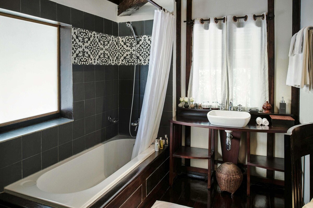 Un baño moderno con bañera, tocador con lavamanos y zona de ducha.