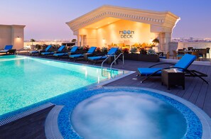 A rooftop pool area with lounge chairs, a hot tub, and a bar named 'MOON DECK'.