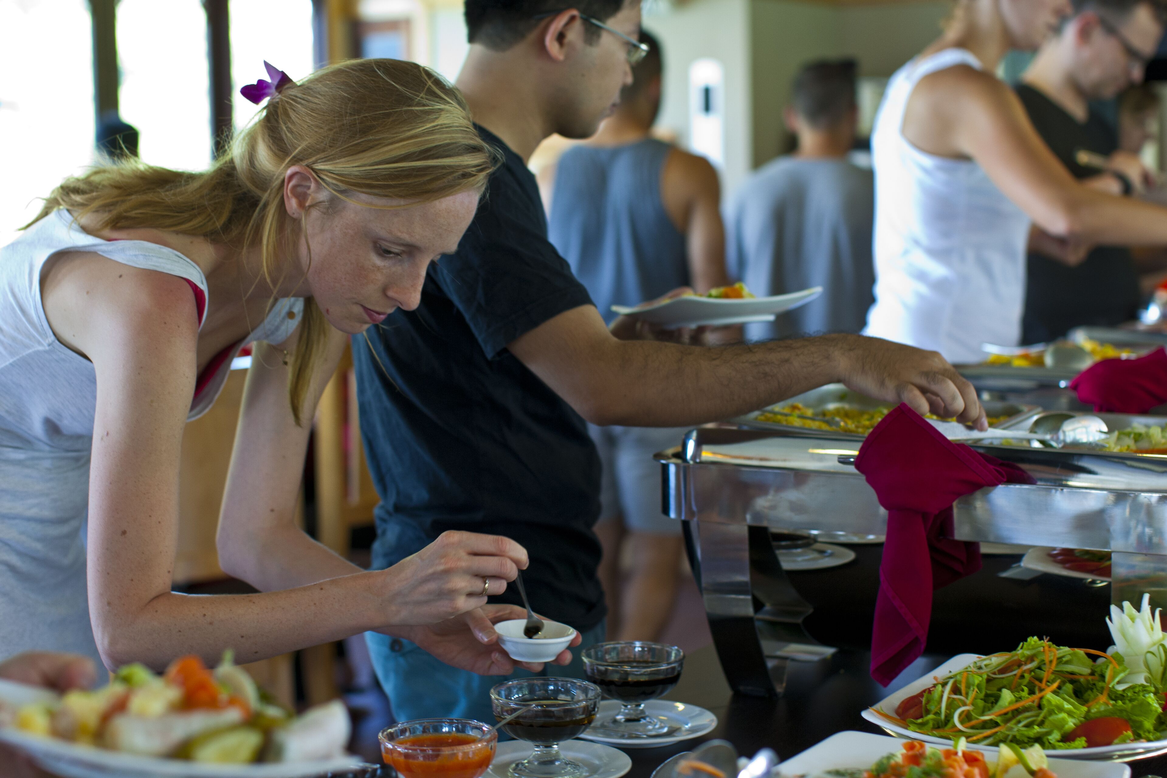 A buffet with various dishes and beverages.