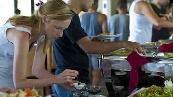 A buffet with various dishes and beverages.