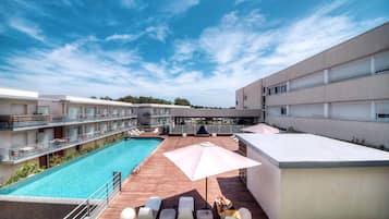 Seasonal outdoor pool, open 9:30 AM to 7:30 PM, pool umbrellas