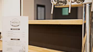 A menu with prix fixe options and a bar area with a tap.