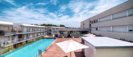 Seasonal outdoor pool, open 9:30 AM to 7:30 PM, pool umbrellas