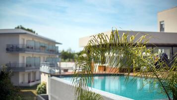 Seasonal outdoor pool, open 9:30 AM to 7:30 PM, pool umbrellas