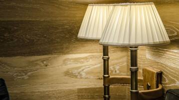 Two lamps with pleated shades on a wooden floor.