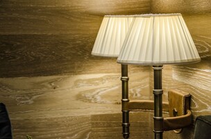Two lamps with pleated shades on a wooden floor.