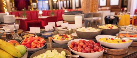 A buffet with various fruits and vegetables.