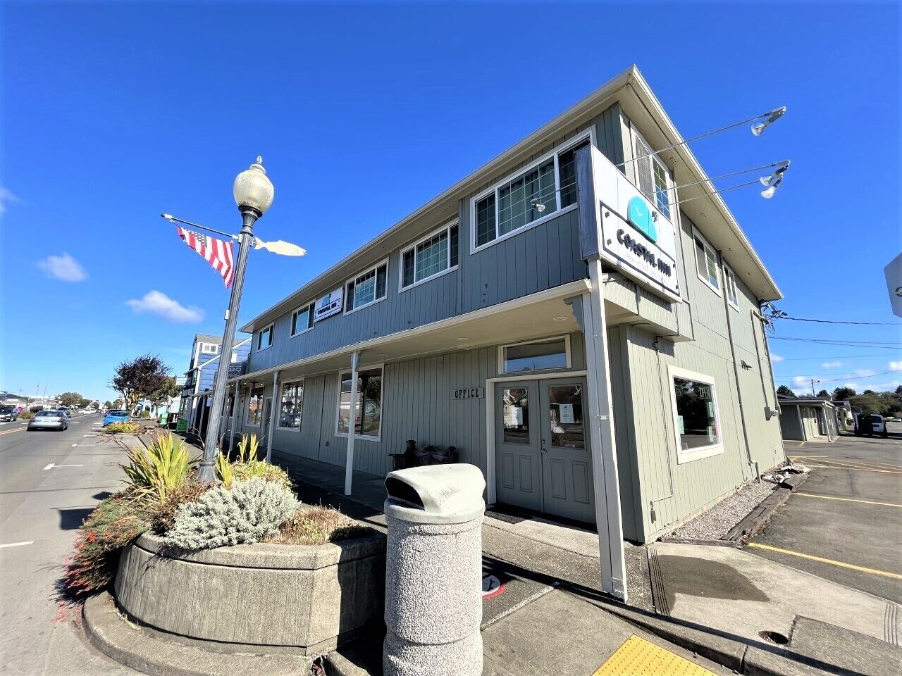 A two-story building with a sign that reads "OFFICE" on the front.