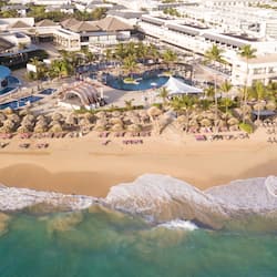 Relax by the ocean at this beachfront resort, featuring rooms with thatched roofs, multiple pools, and beachside dining options.