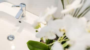 A bathroom sink with a chrome faucet and a drain.