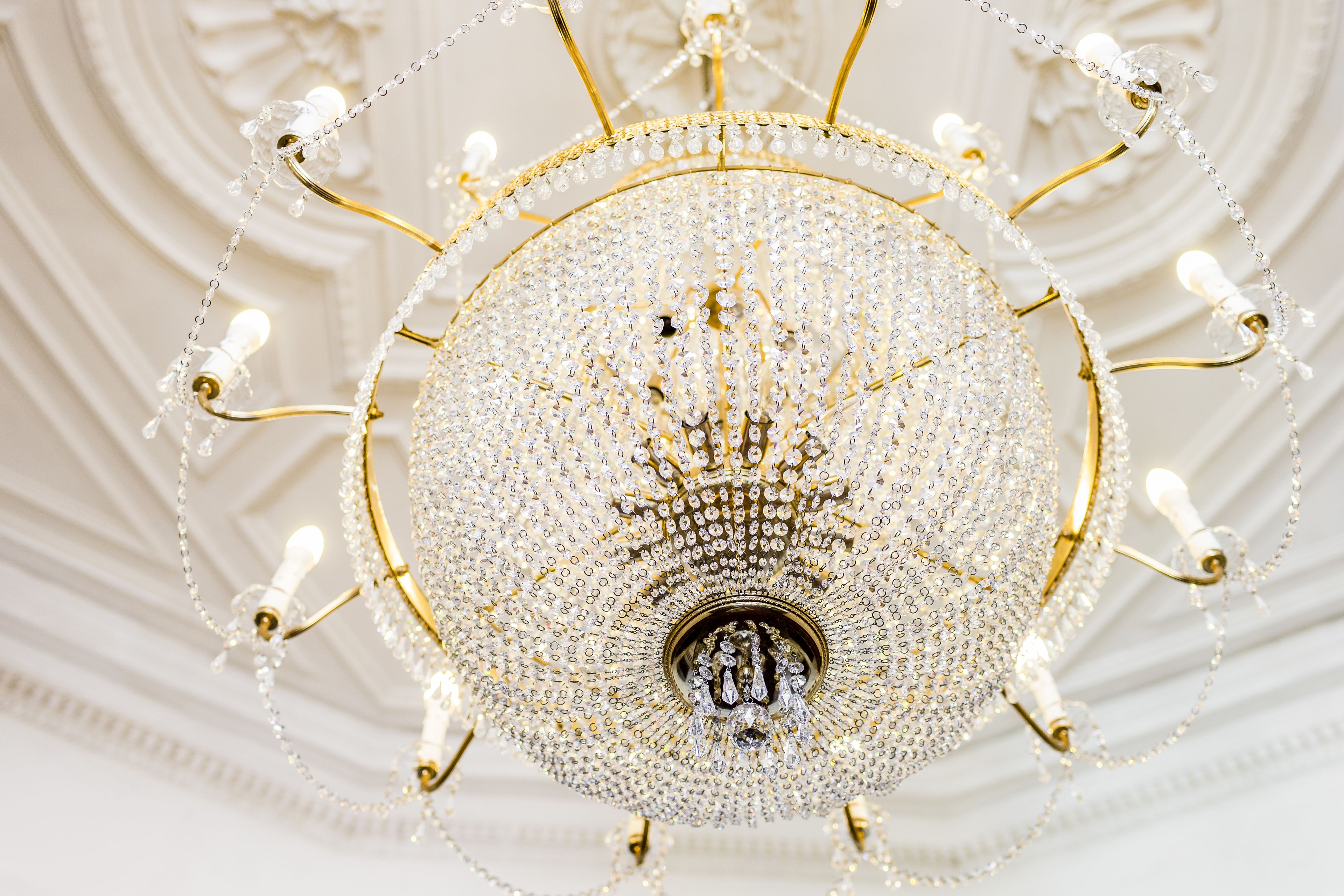 A chandelier with multiple arms and crystal decorations.