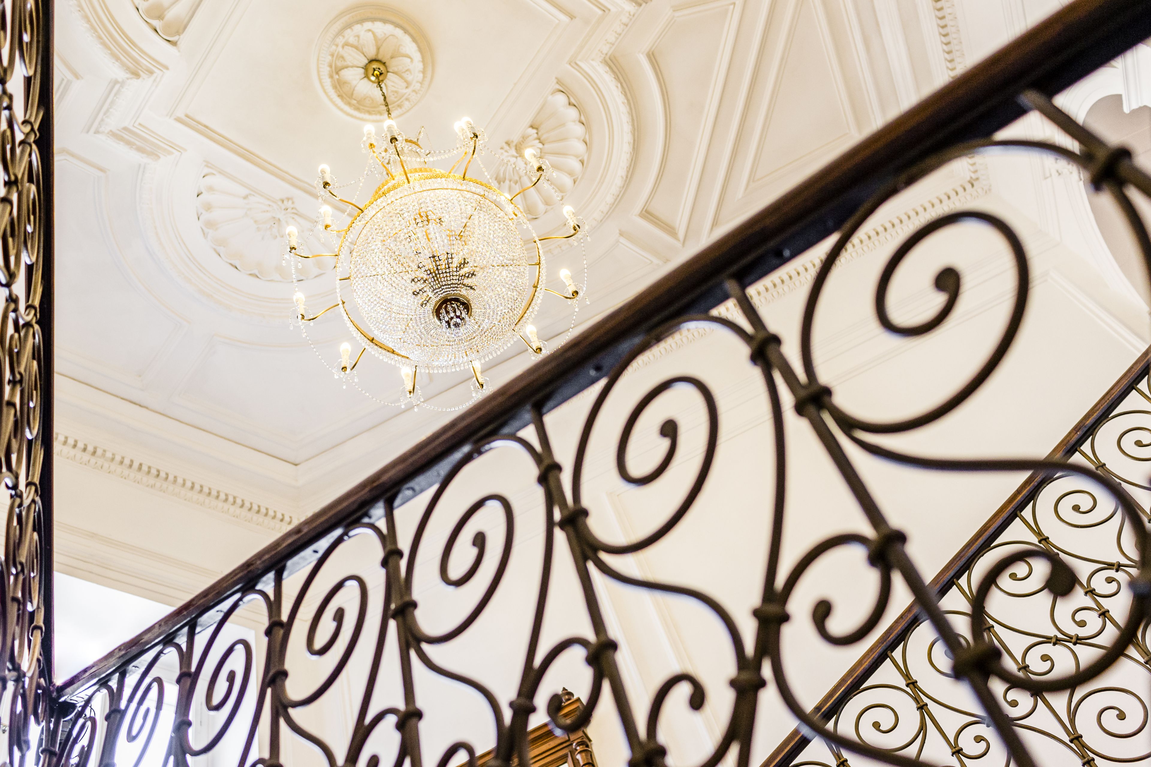 A chandelier with multiple light fixtures and a decorative ceiling.