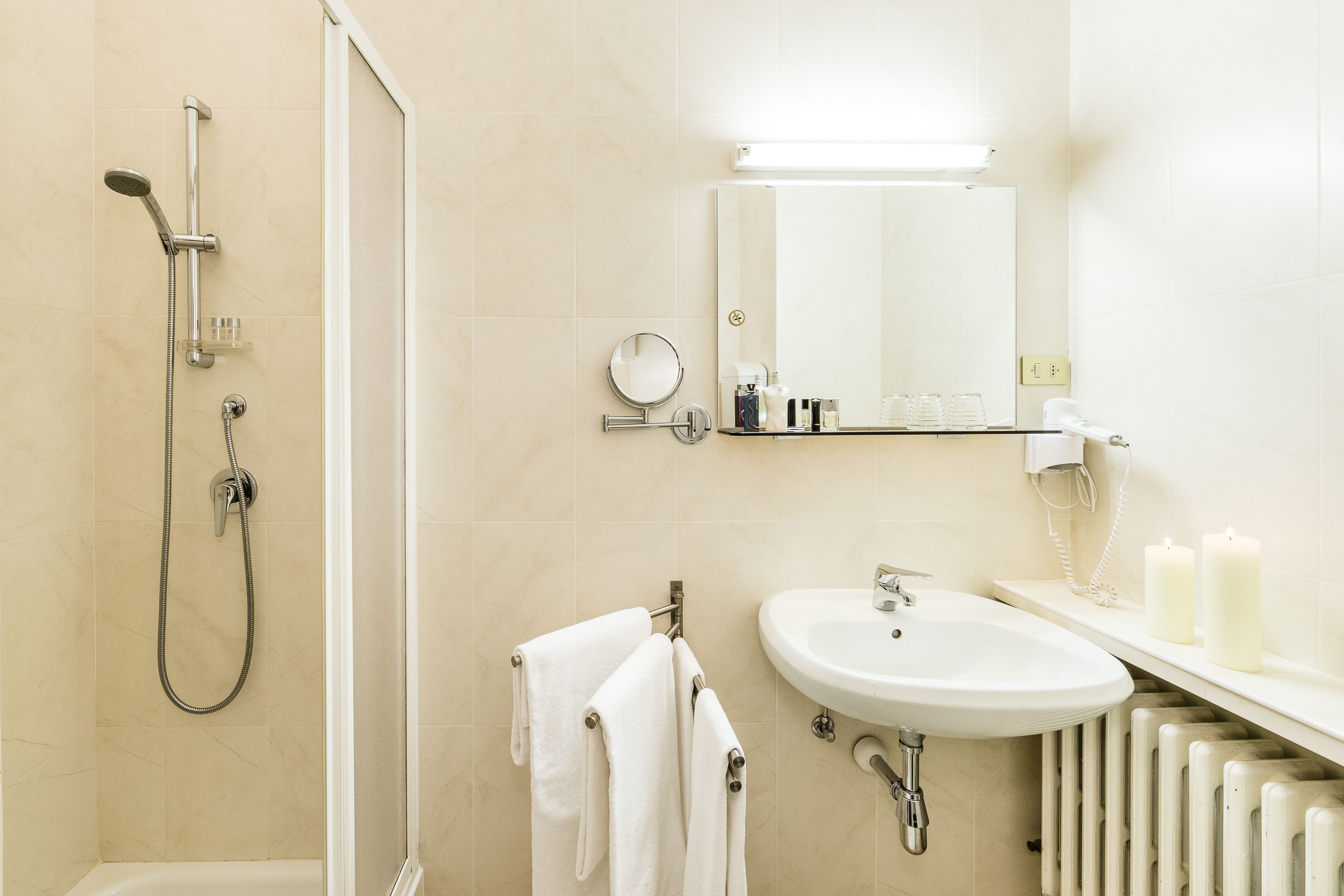 A modern bathroom with a shower, sink, and mirror.