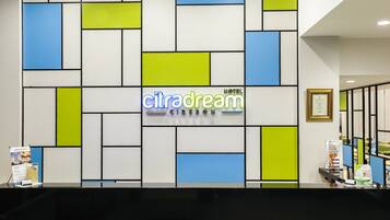 A reception area with a geometric wall design, a sign reading "citradream," and a framed certificate on the wall.