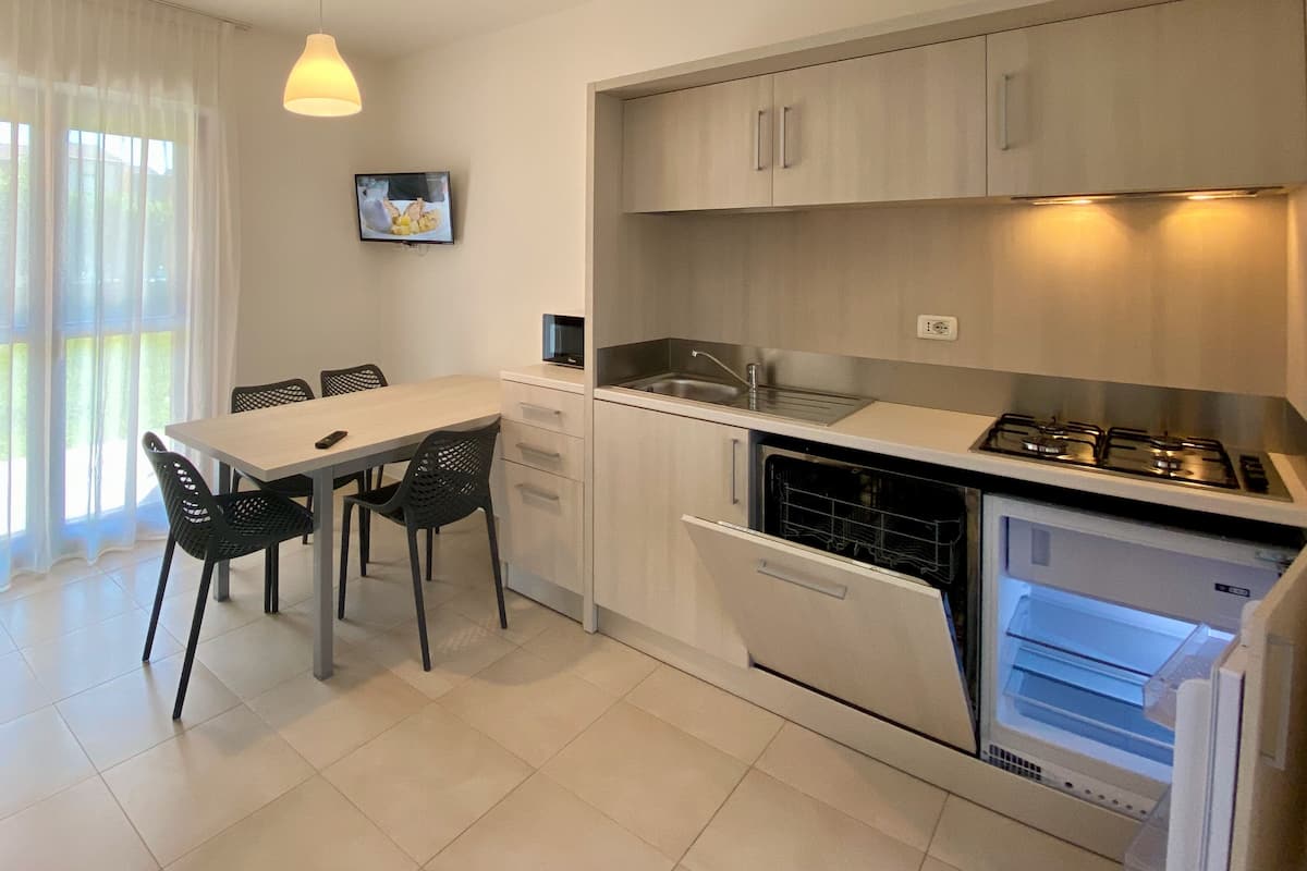 Standard Apartment, 2 Bedrooms (Ground Floor) | Private kitchen | Full-size fridge, microwave, stovetop, cookware/dishes/utensils