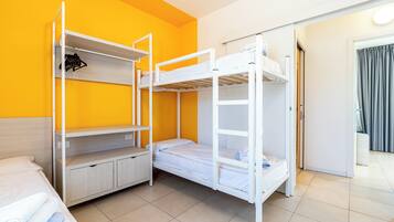 A bunk bed room with a wardrobe and a small desk.