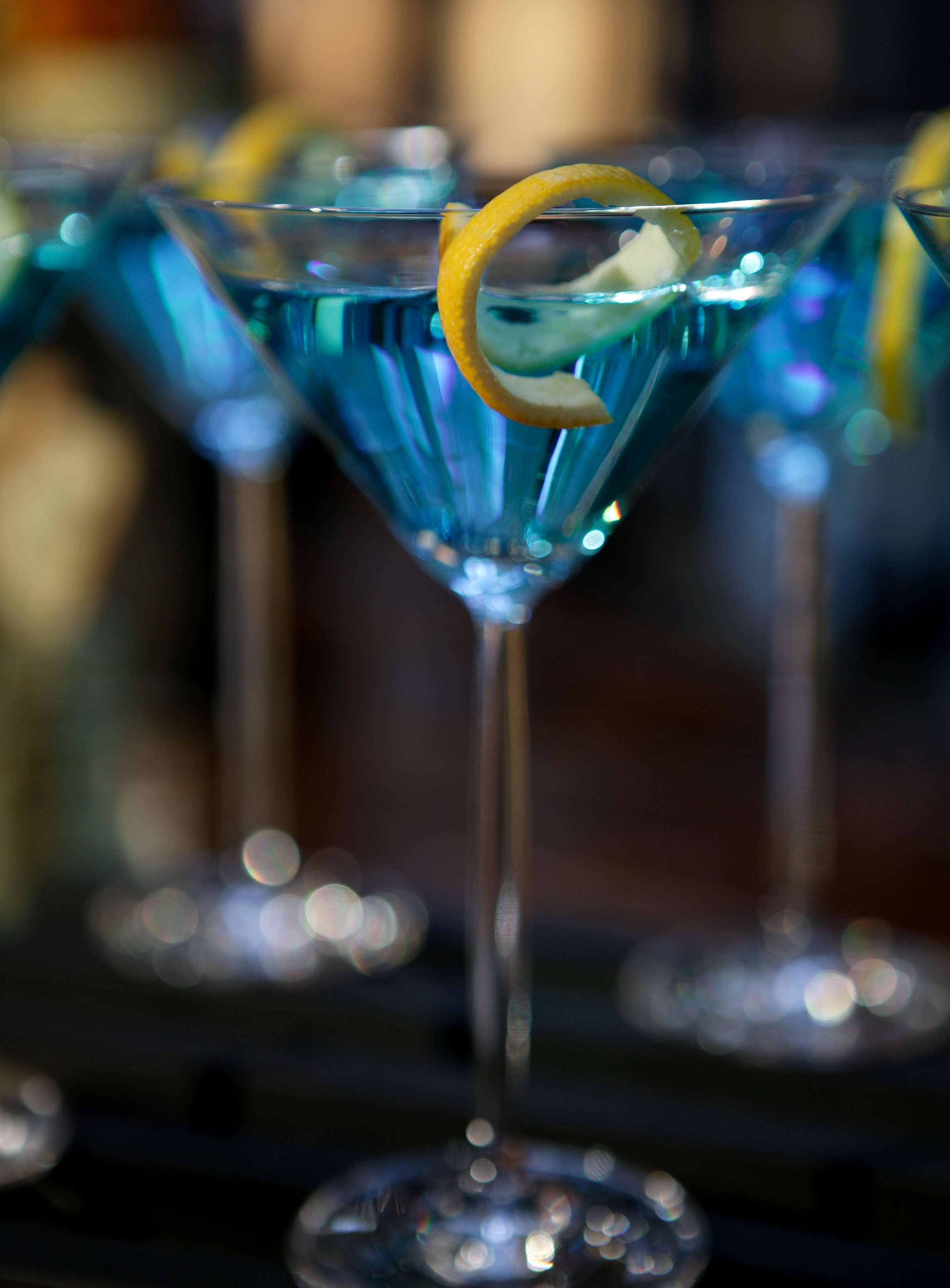 A close-up of a martini glass with a lemon twist garnish.