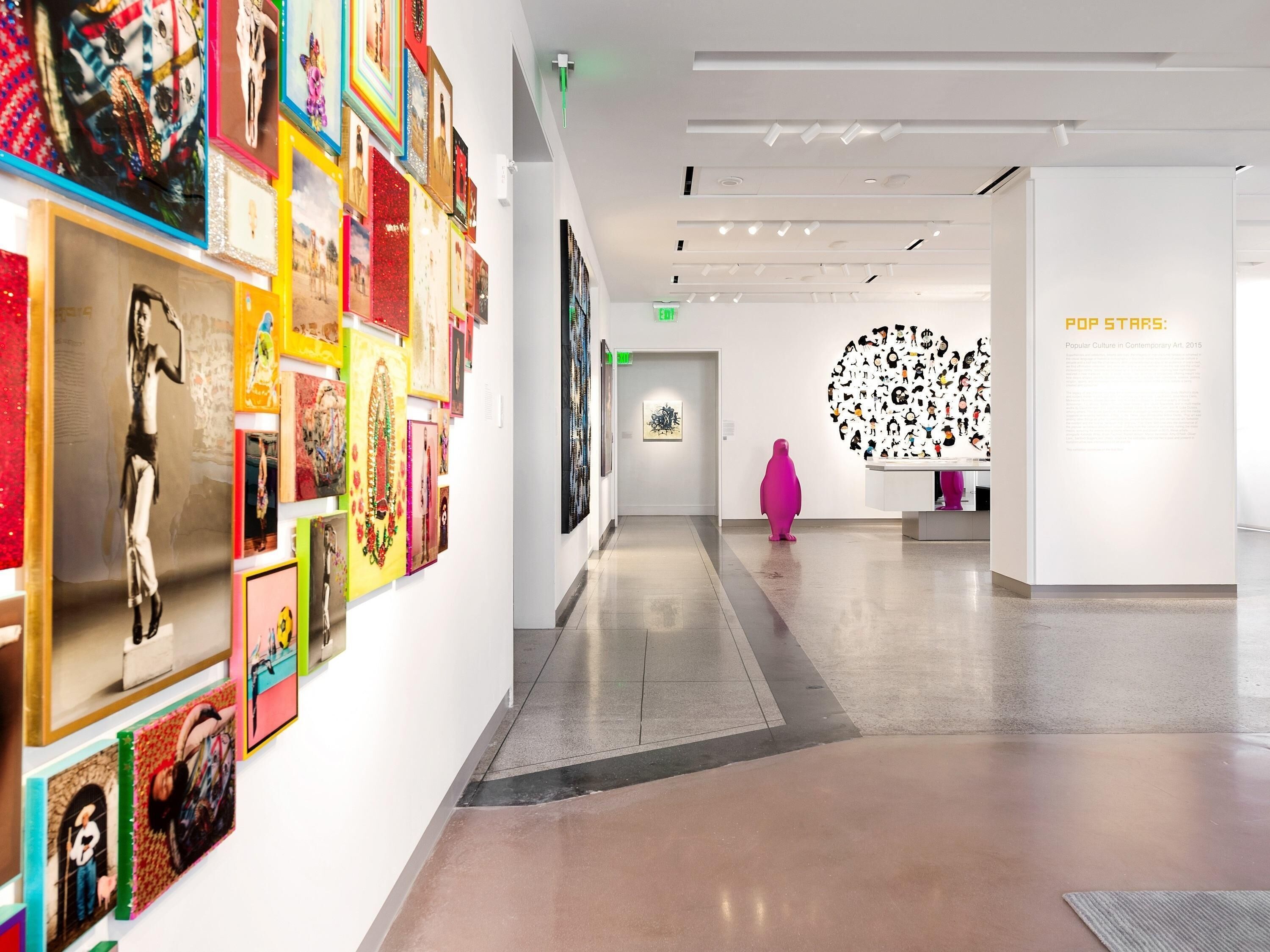 An art gallery with a variety of colorful artworks on display.