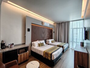 A hotel room with two beds, a desk, a coffee machine, and a TV. - Hotel Block Suites (Mexico City)