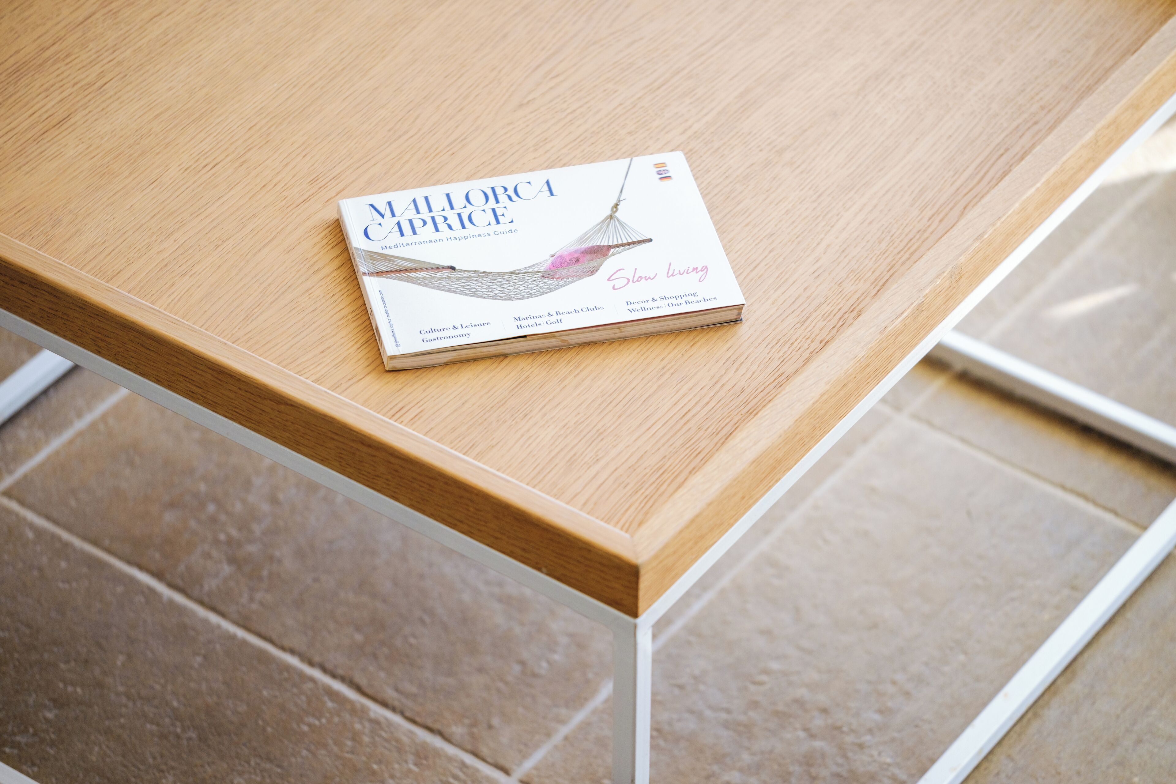 A book titled 'Mallorca Caprice' on a wooden table.