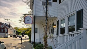 A white building with a sign reading "The Little Fig Hotel 109." - Little Fig Hotel (Bar Harbor)