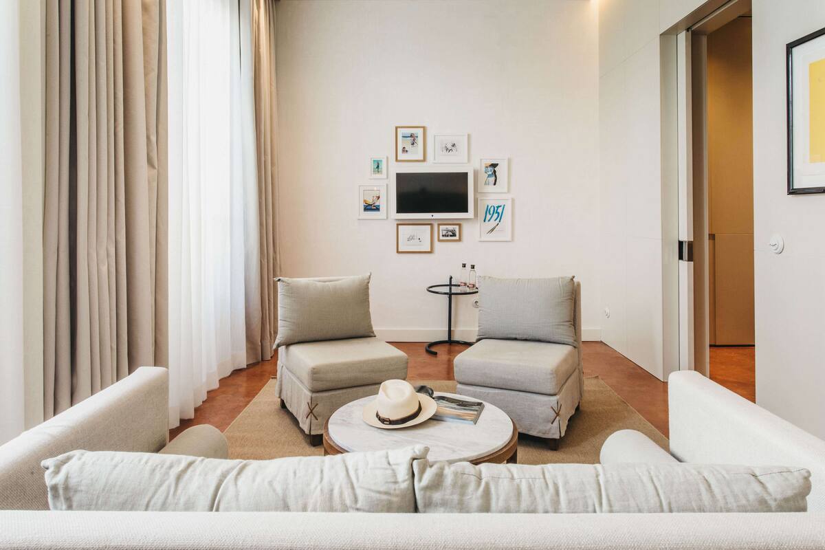 A modern living room with two sofas, a coffee table, and a TV.