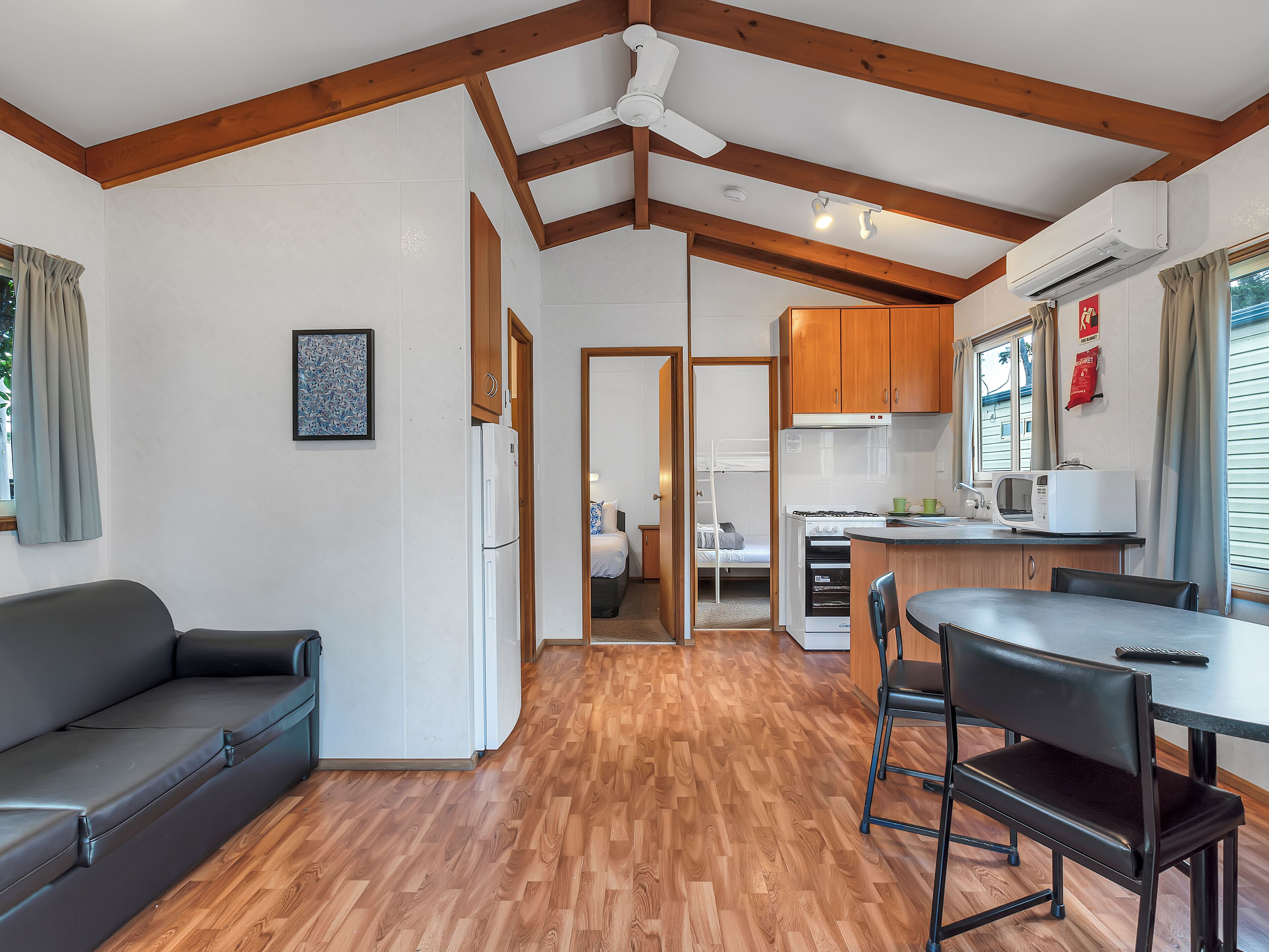 A compact living space with a kitchenette, a dining area, and a sleeping area.