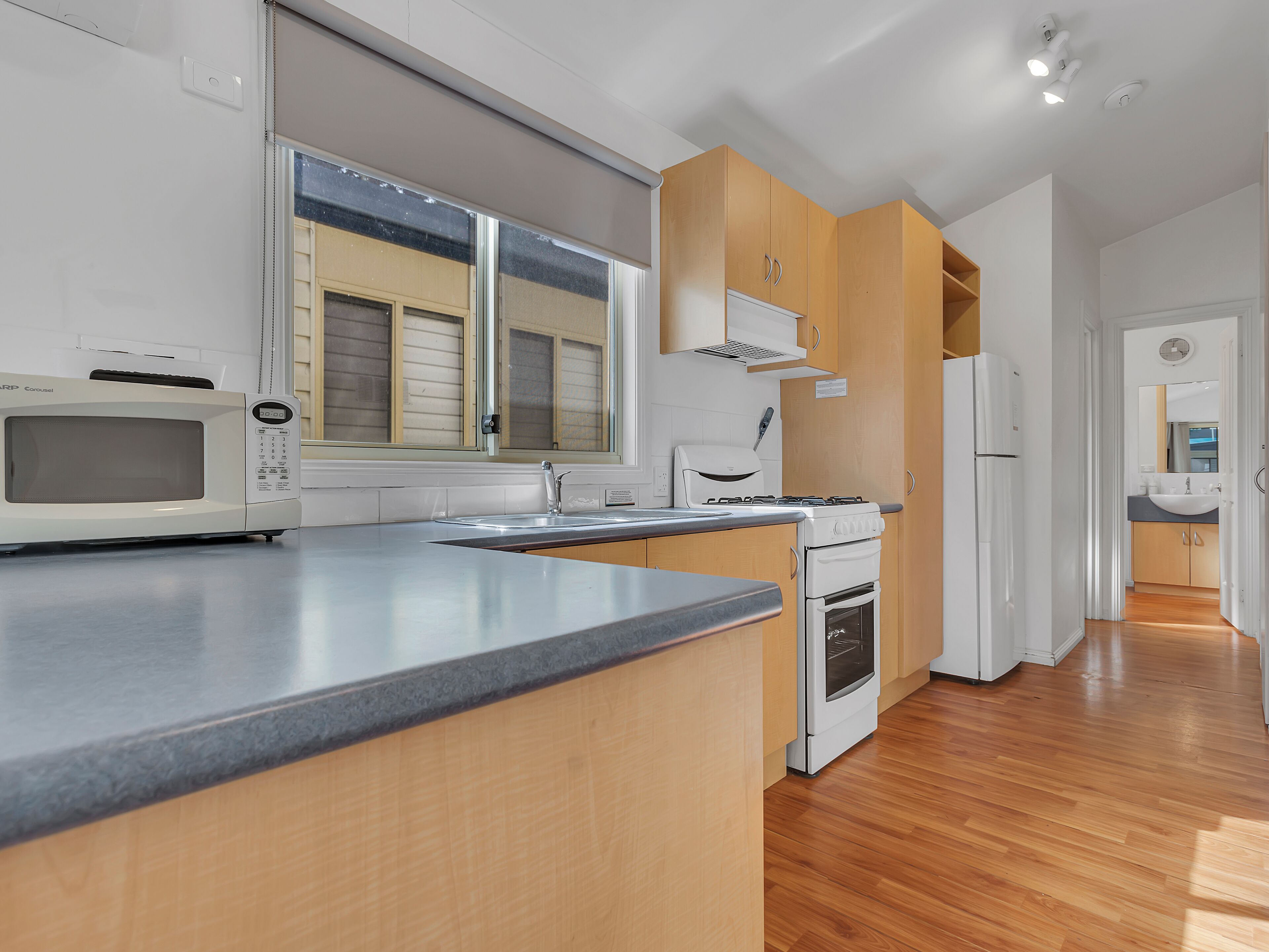 A modern kitchen with a built-in microwave, stove, and sink.