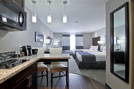 Deluxe Room, Kitchenette (with 2 Queen Beds) | Premium bedding, desk, laptop workspace, blackout drapes. Home Inn and Suites Regina Airport