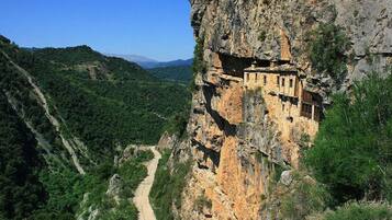 A cliffside building with a narrow path leading up.