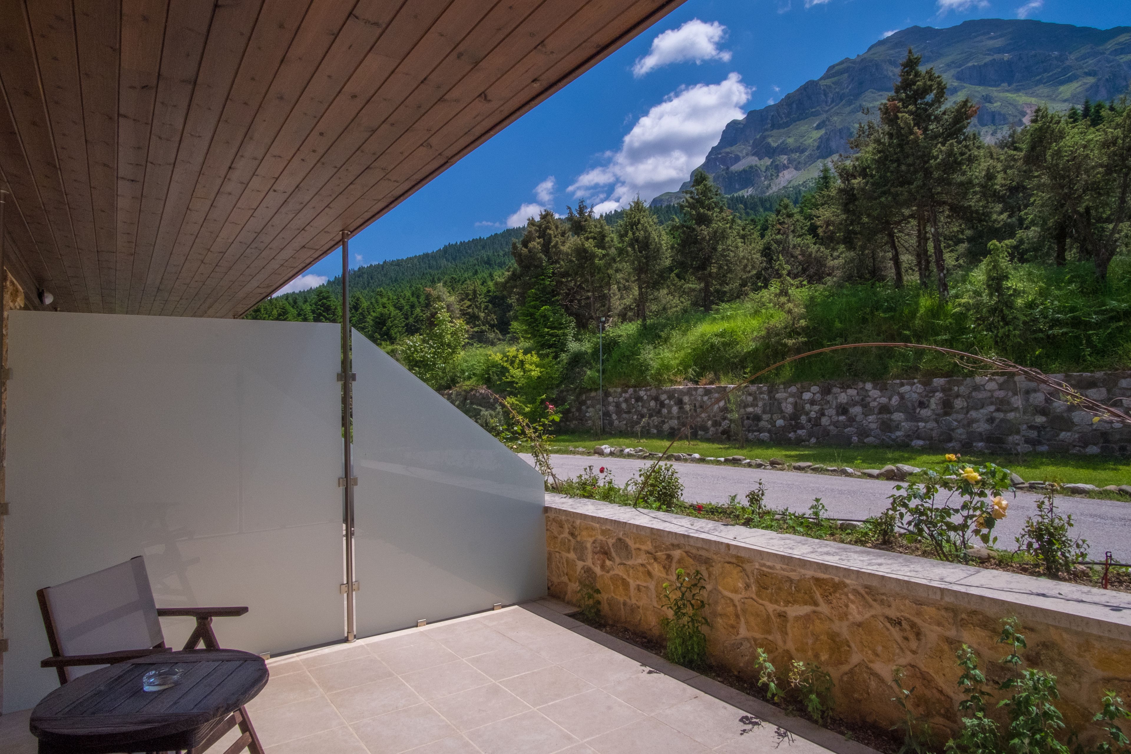 A balcony with a view of a mountain and a road.
