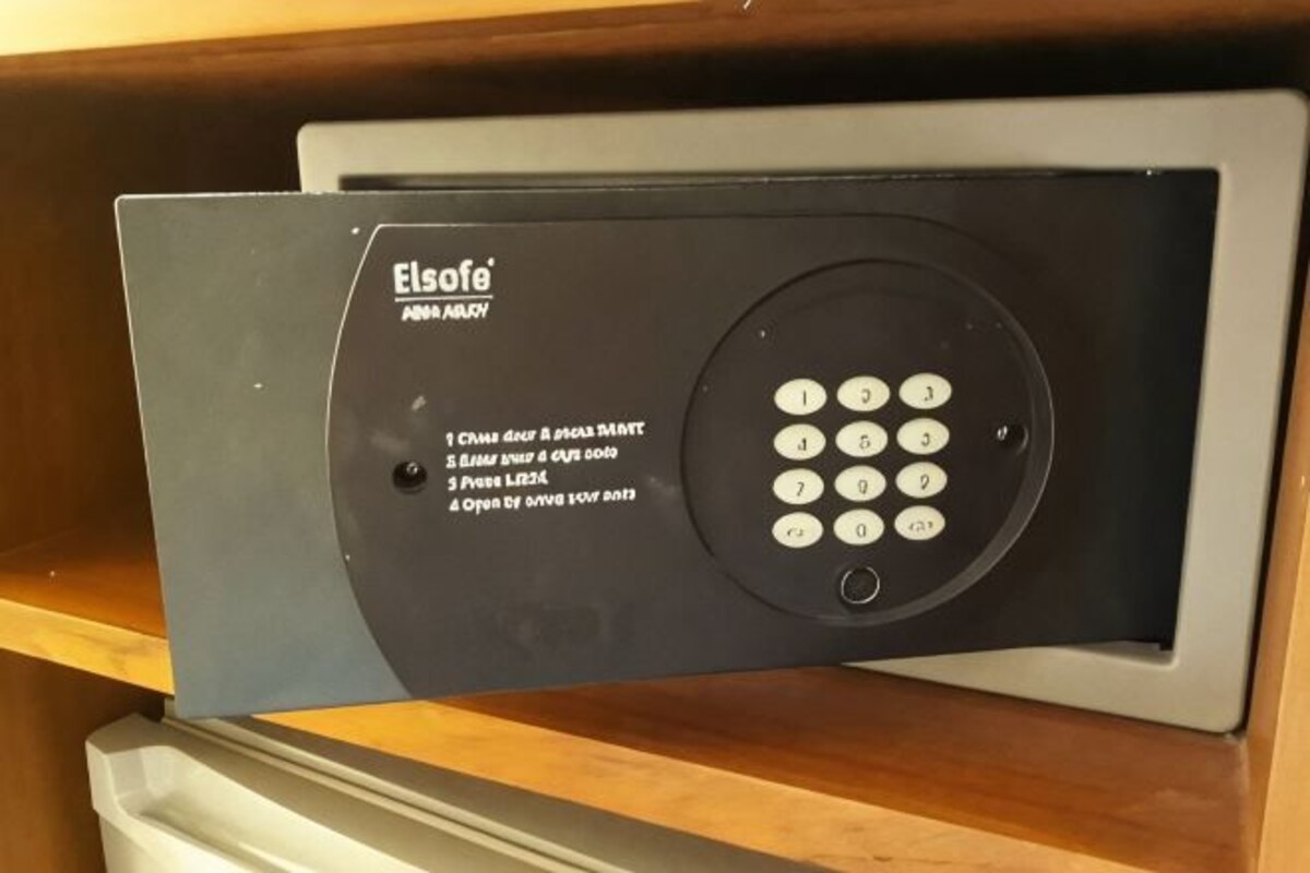A black security keypad with instructions for use, mounted on a wooden surface.