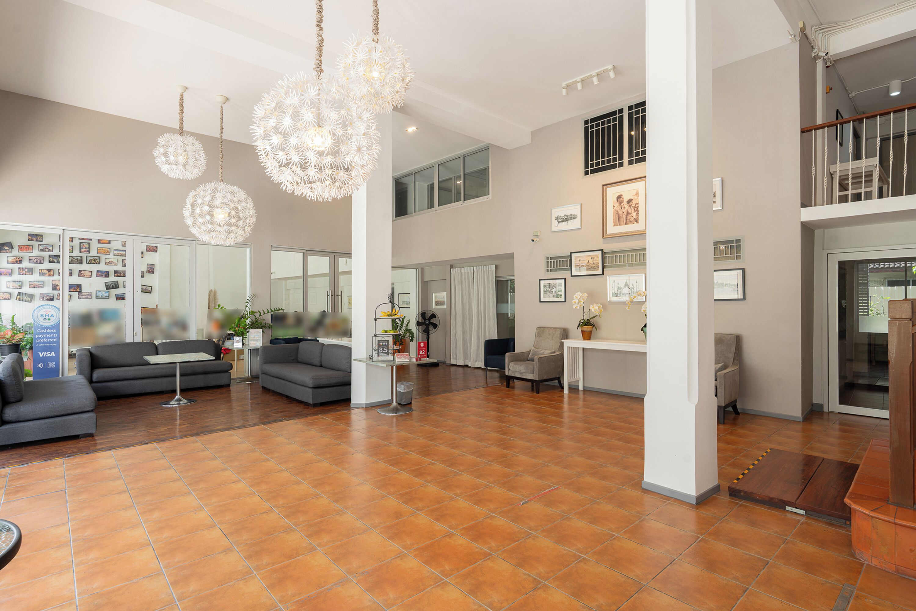 A spacious living area with modern decor, including a large sofa, a coffee table, and decorative lighting.