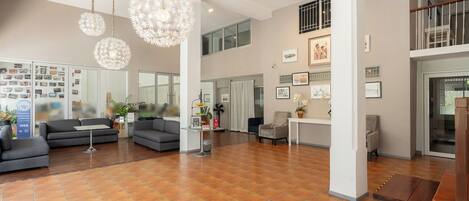 A spacious living area with modern decor, including a large sofa, a coffee table, and decorative lighting.