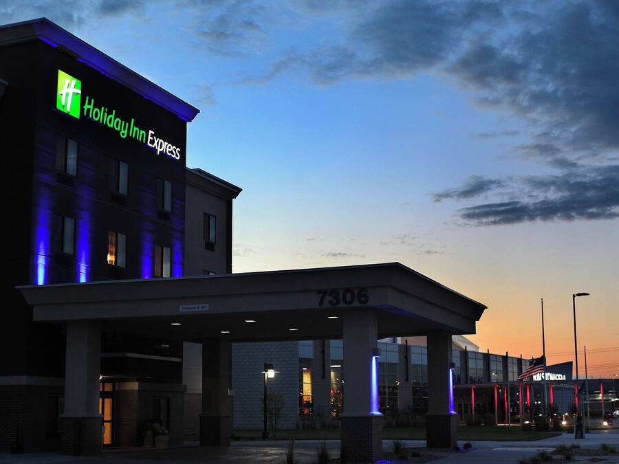A Holiday Inn Express building with a clear sky and a sunset.