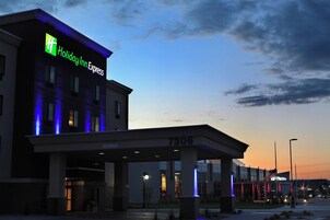 A Holiday Inn Express building with a clear sky and a sunset.