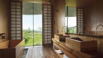Enjoy a serene bathroom retreat with a bathtub, two sinks, and a scenic view.