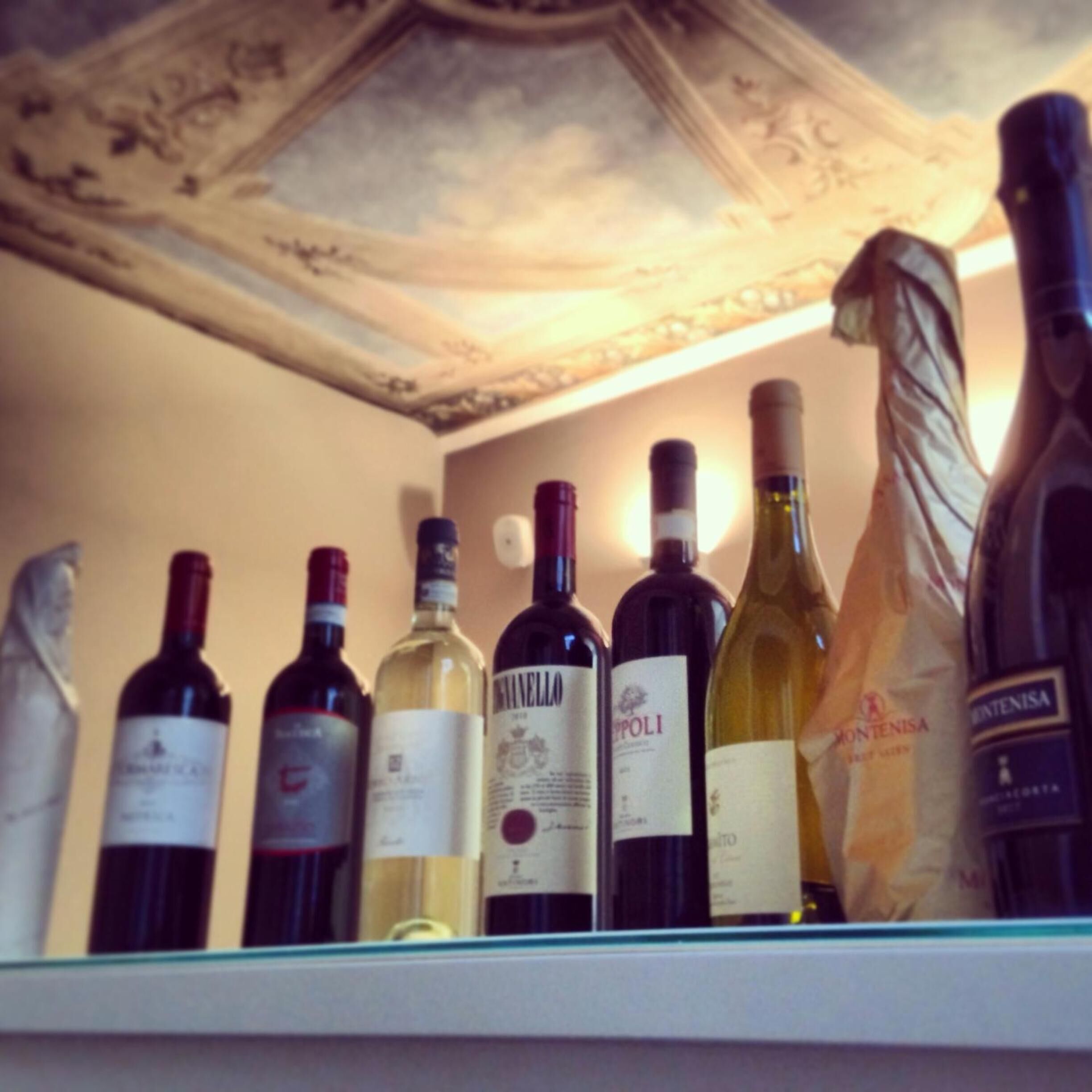 A wine rack with various bottles of wine.