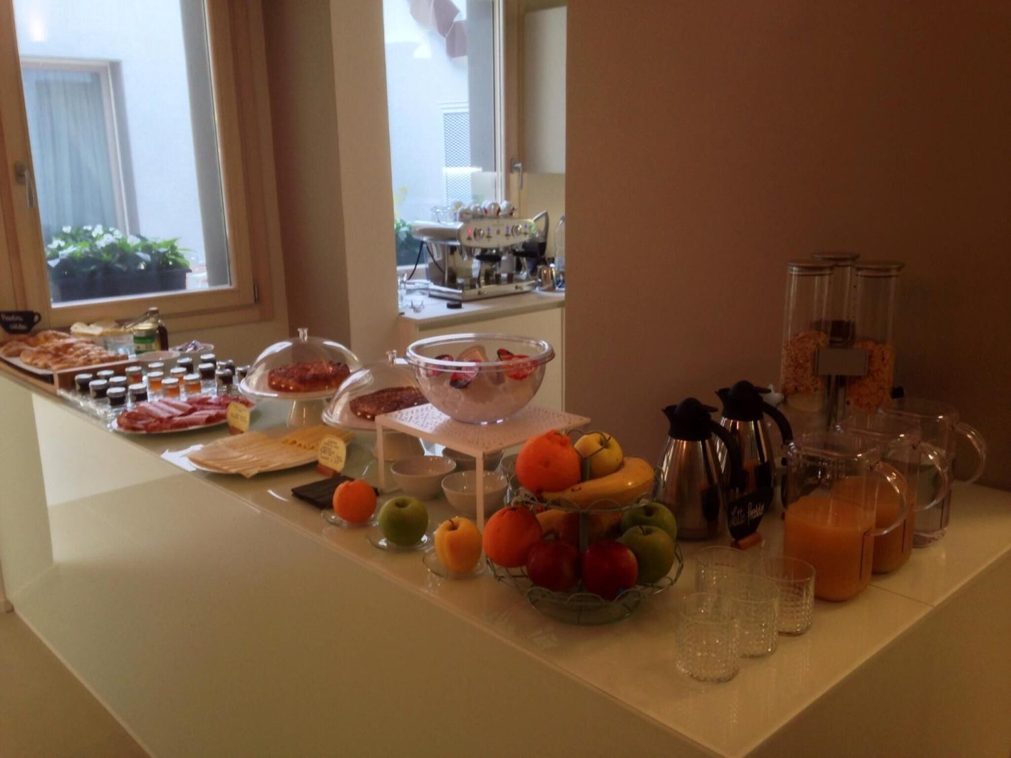 A breakfast buffet with various food items and beverages.