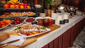 A buffet with various food items and condiments.