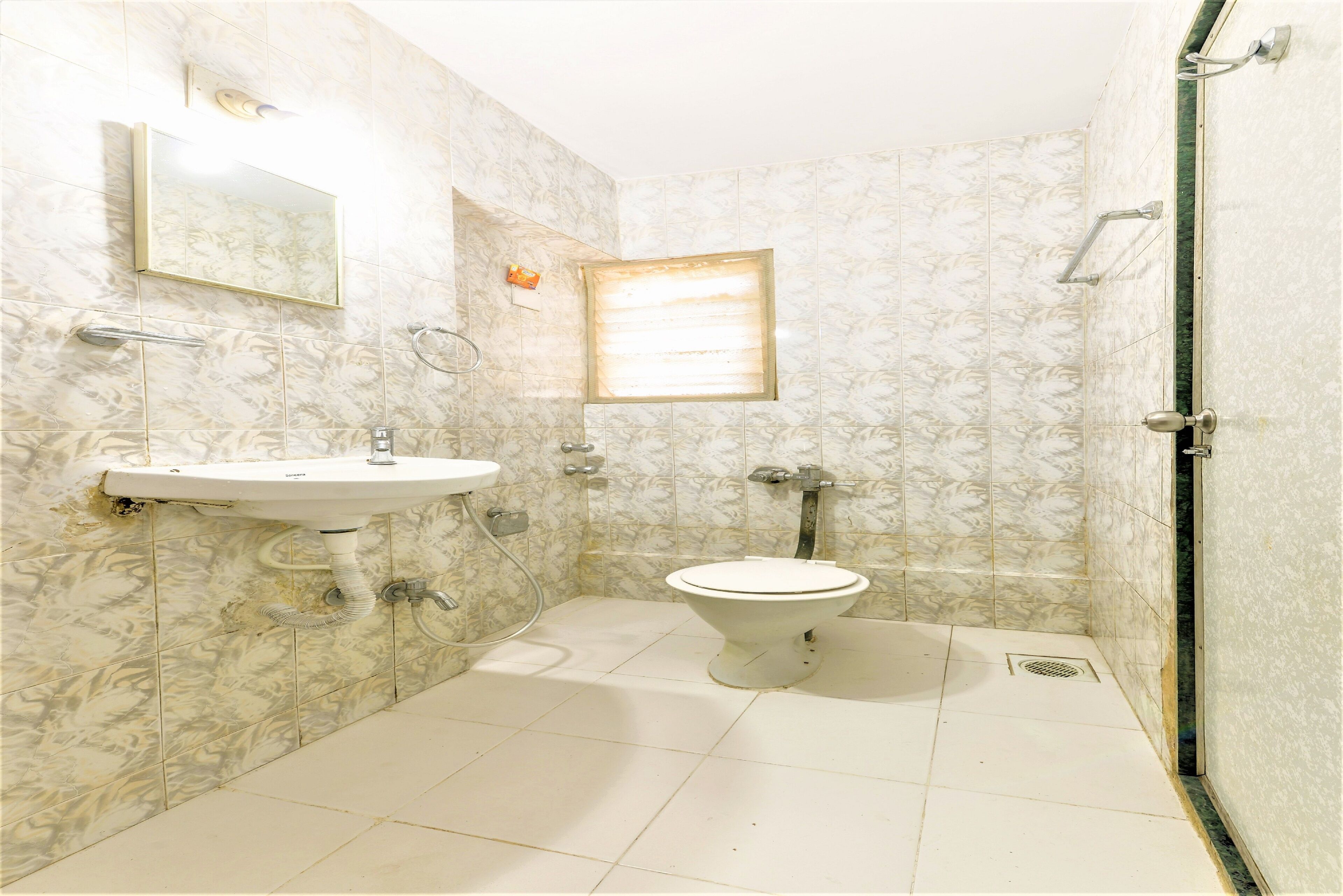 A bathroom with a toilet, sink, and shower.